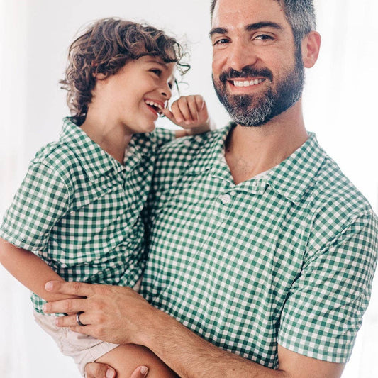 A man holding his son in a Polo - Sage Gingham shirt by Sugar Bee Clothing.