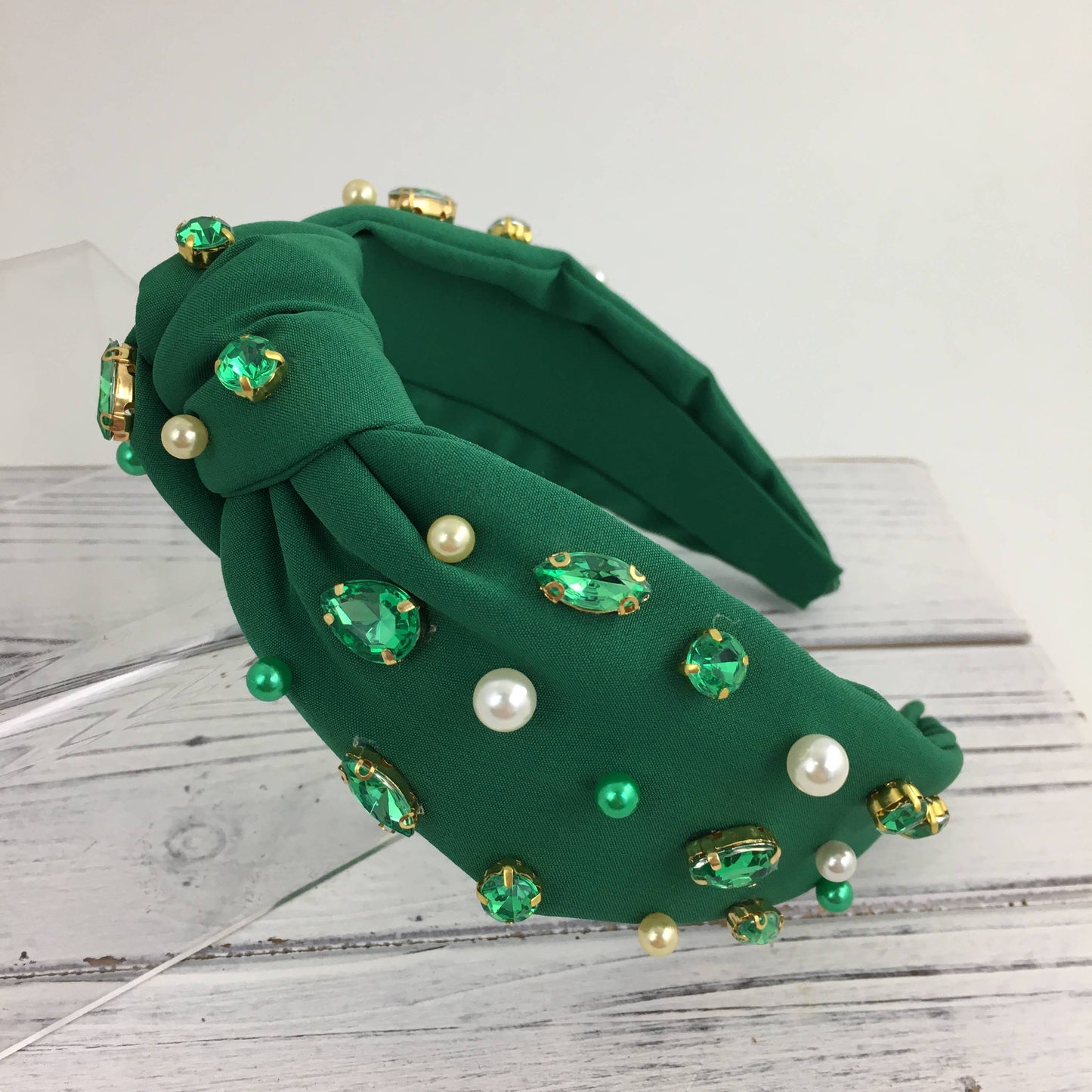 A SongLily green stone/ pearl fashion knot headband adorned with pearls and rhinestones.