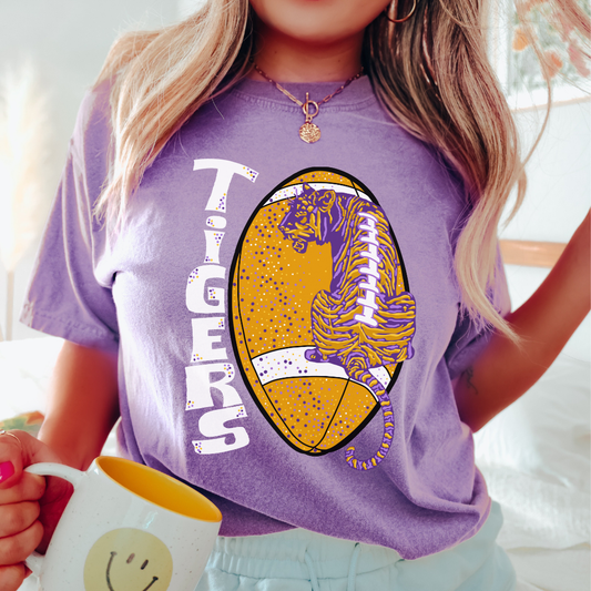 A woman wearing a Laces Out! LSU Tigers Football Game Day Tee by Pink House On River Road holding a mug.