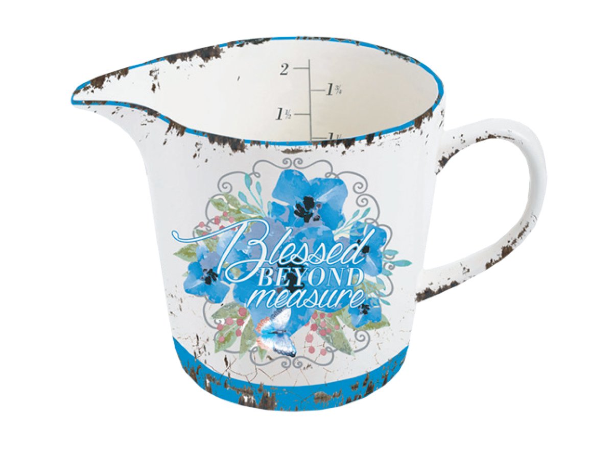 A Blessed Beyond Measuring Cup by Nicole Brayden with blue flowers painted on it.