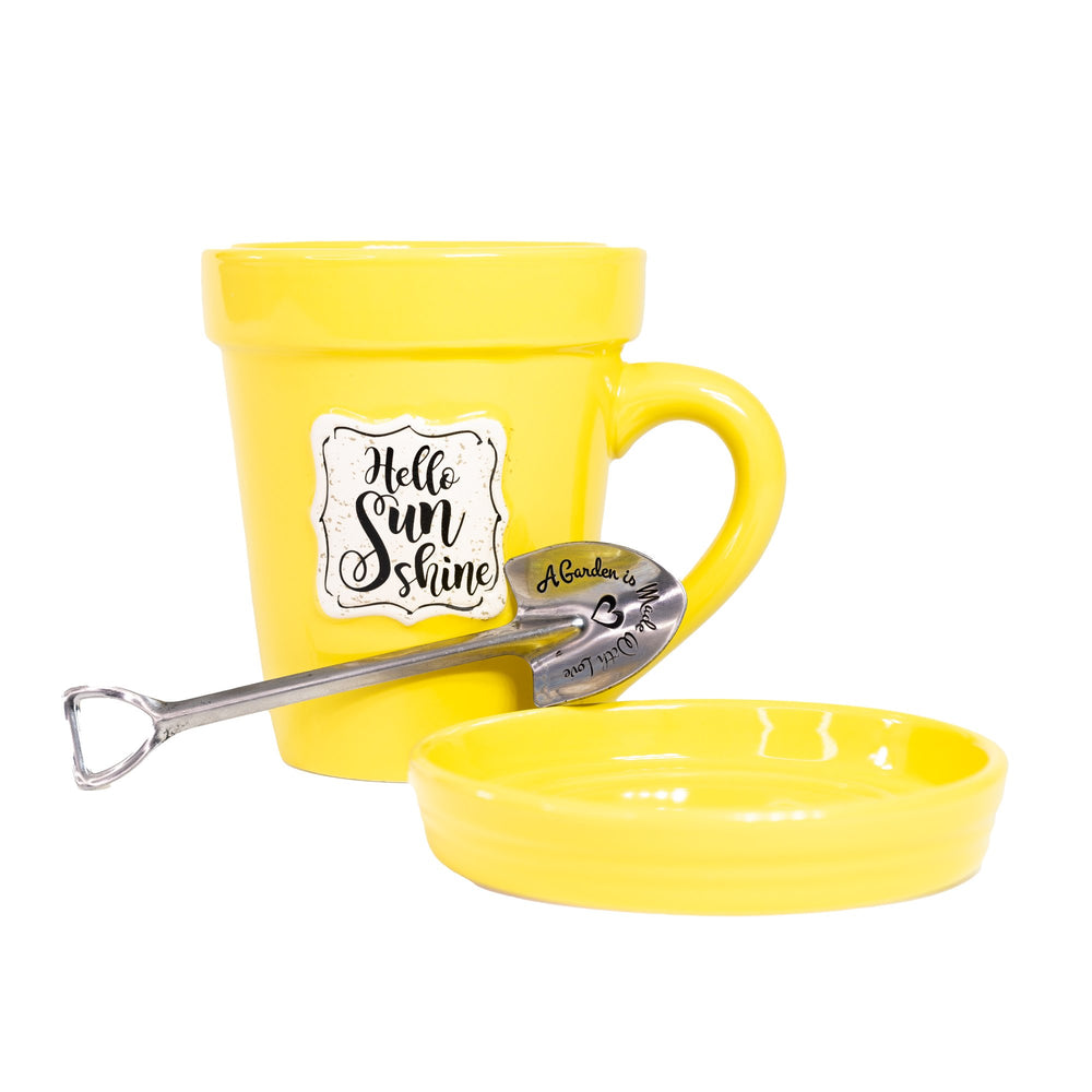 The Nicole Brayden Hello Sunshine Yellow Flower Pot Mug comes with a spoon and saucer.