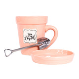A Peach Flower Pot Mug - You Are Loved with a spoon inside of it by Nicole Brayden.