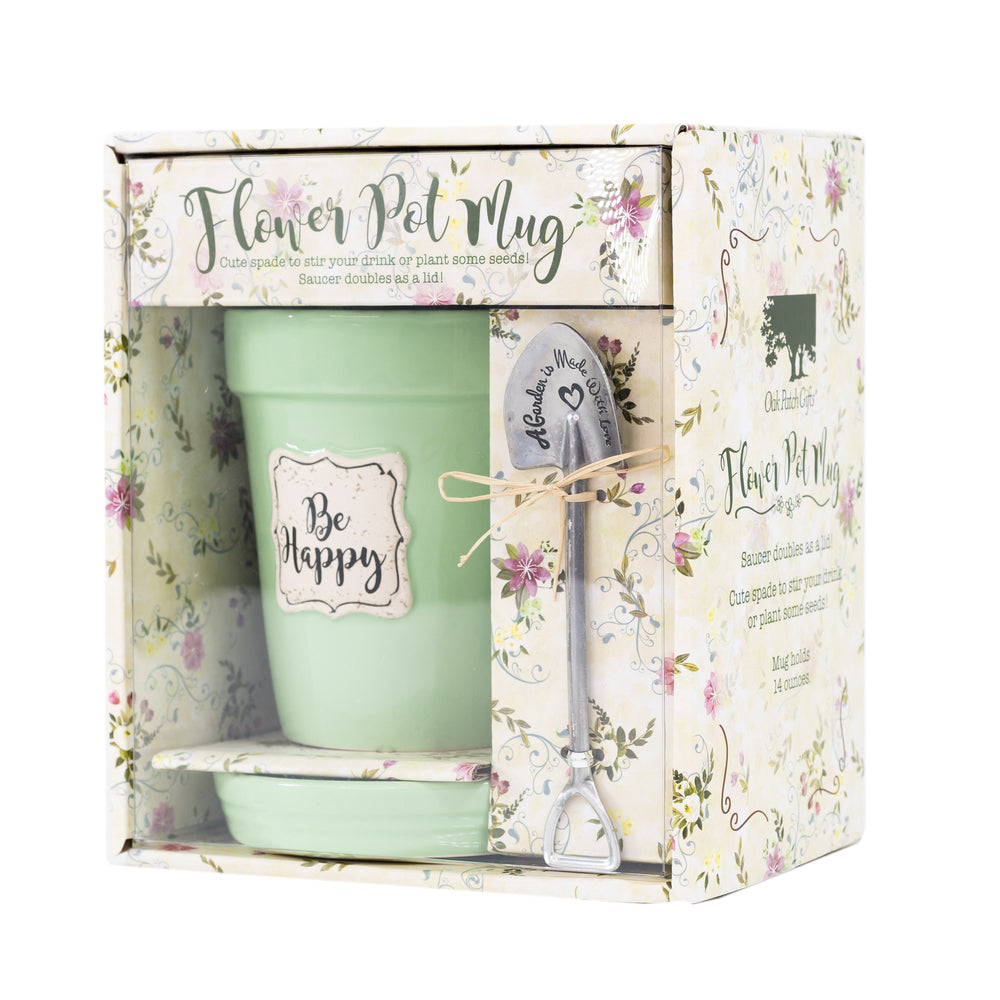 A Green Flower Pot Mug - Be Happy and saucer in a box with a spoon by Nicole Brayden.
