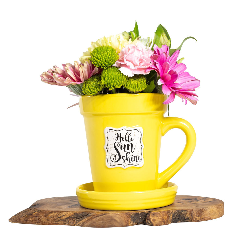 A Yellow Flower Pot Mug - Hello Sunshine by Nicole Brayden with flowers in it.