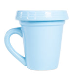 A blue flower pot mug with a lid on a white background from Nicole Brayden.