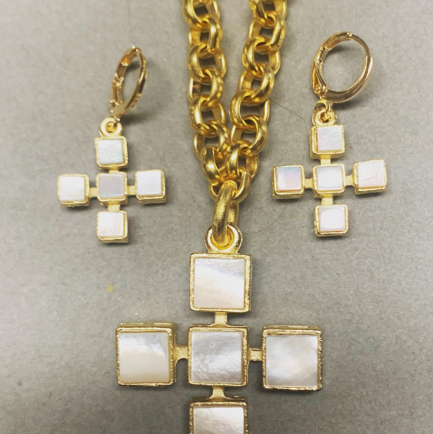 A set of Weisinger Designs jewelry including a MOP Cross Necklace 21", bracelet, and ring.