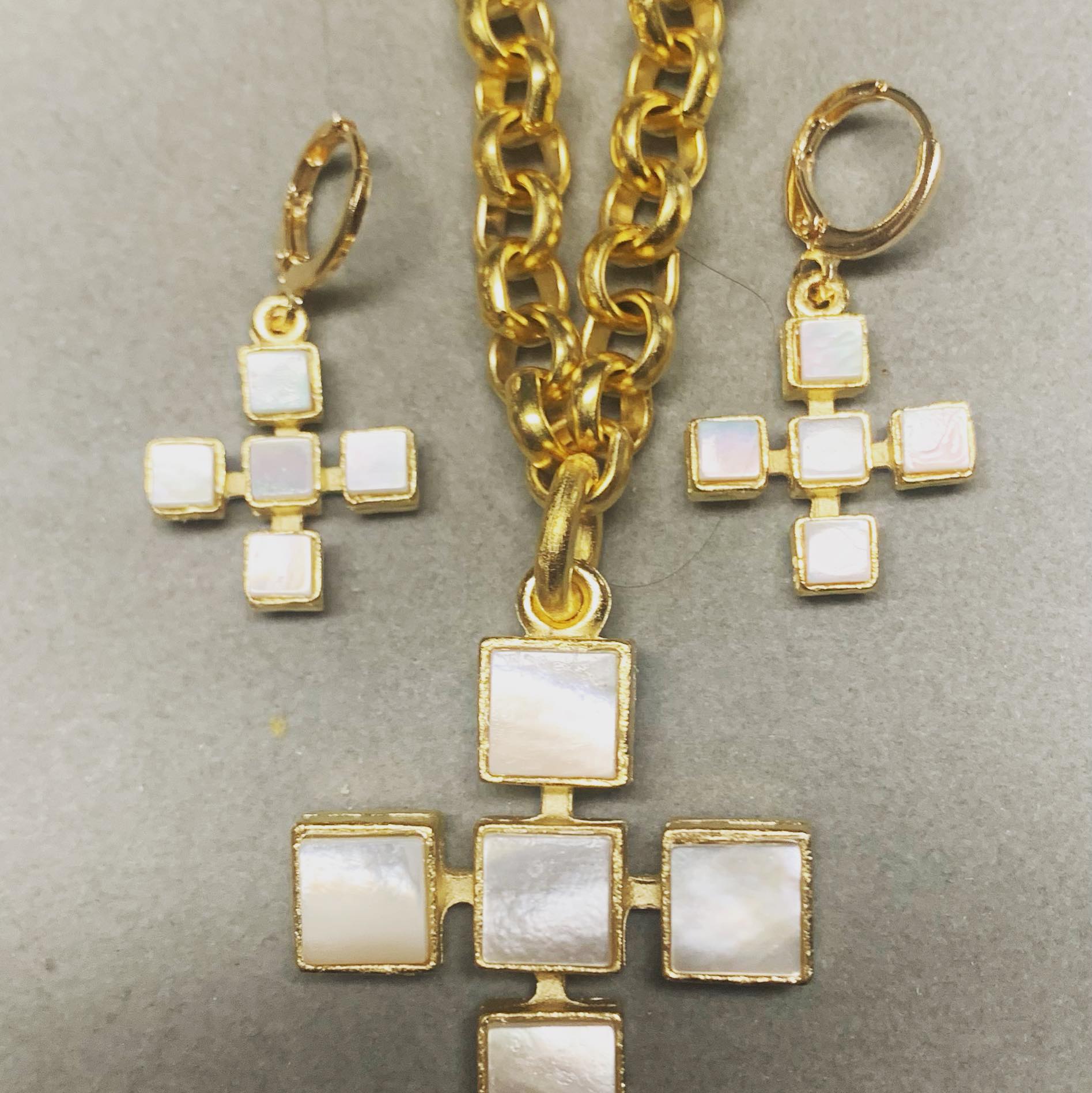 a set of Weisinger Designs jewelry including a necklace, bracelet, and ring, and MOP Cross Earrings.