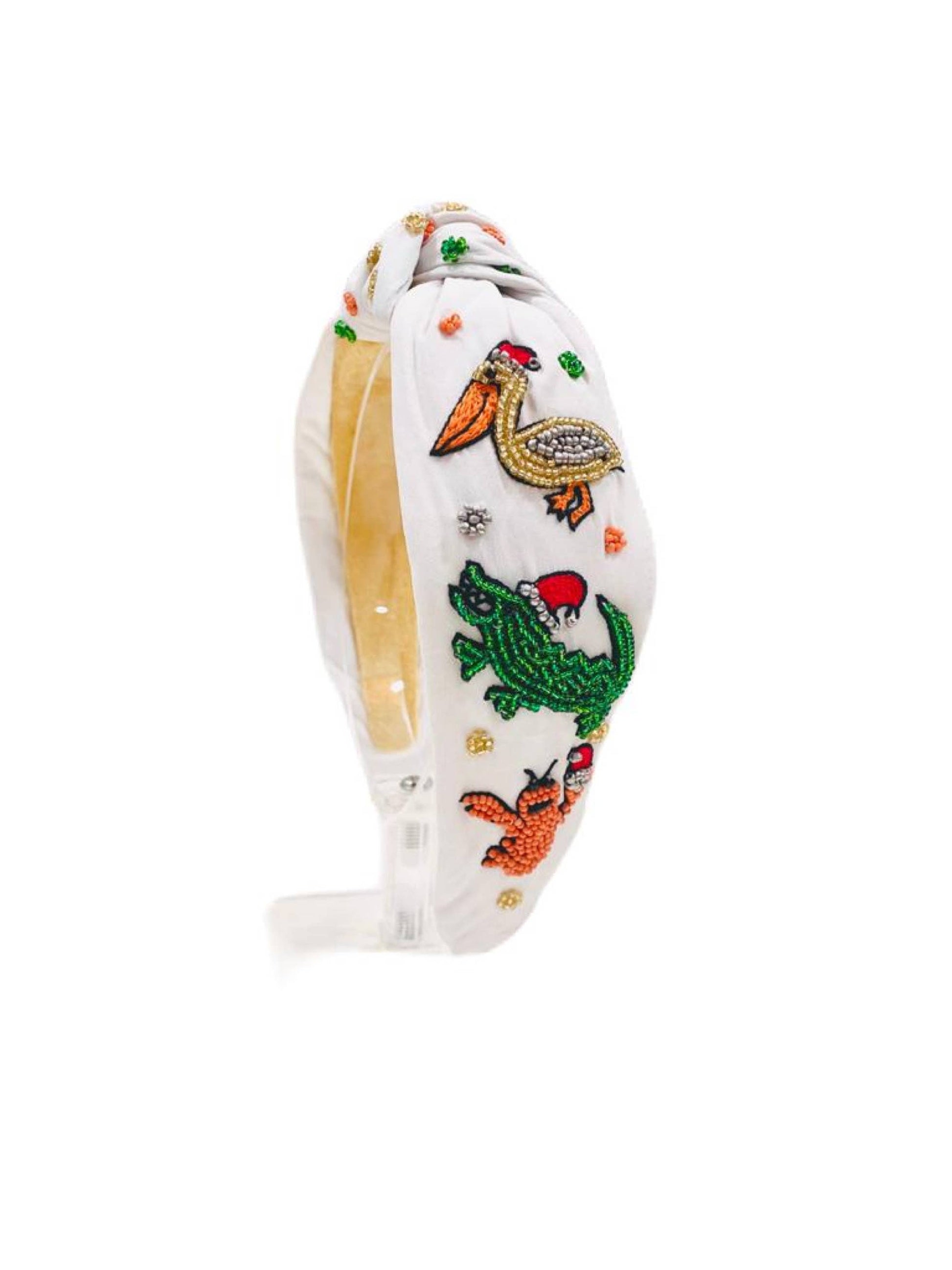A Cajun Christmas Headband by SeersuckerJOEY LLC with embroidered animals on it.