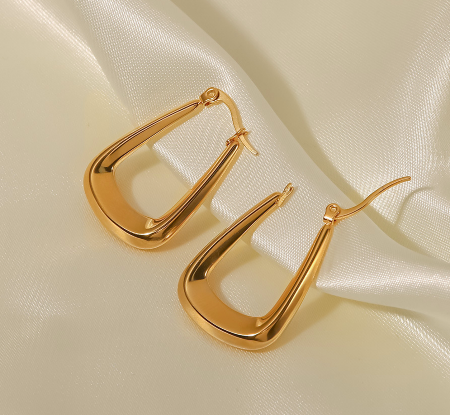A pair of 18K gold plated hoop earrings in a WS-Trapezoid style by 3Souls Company.