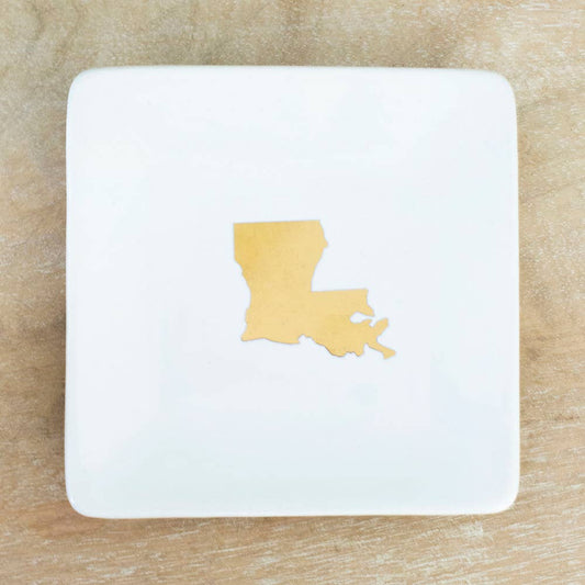 A white Louisiana Trinket Dish with a yellow state cut out of it, by The Royal Standard.